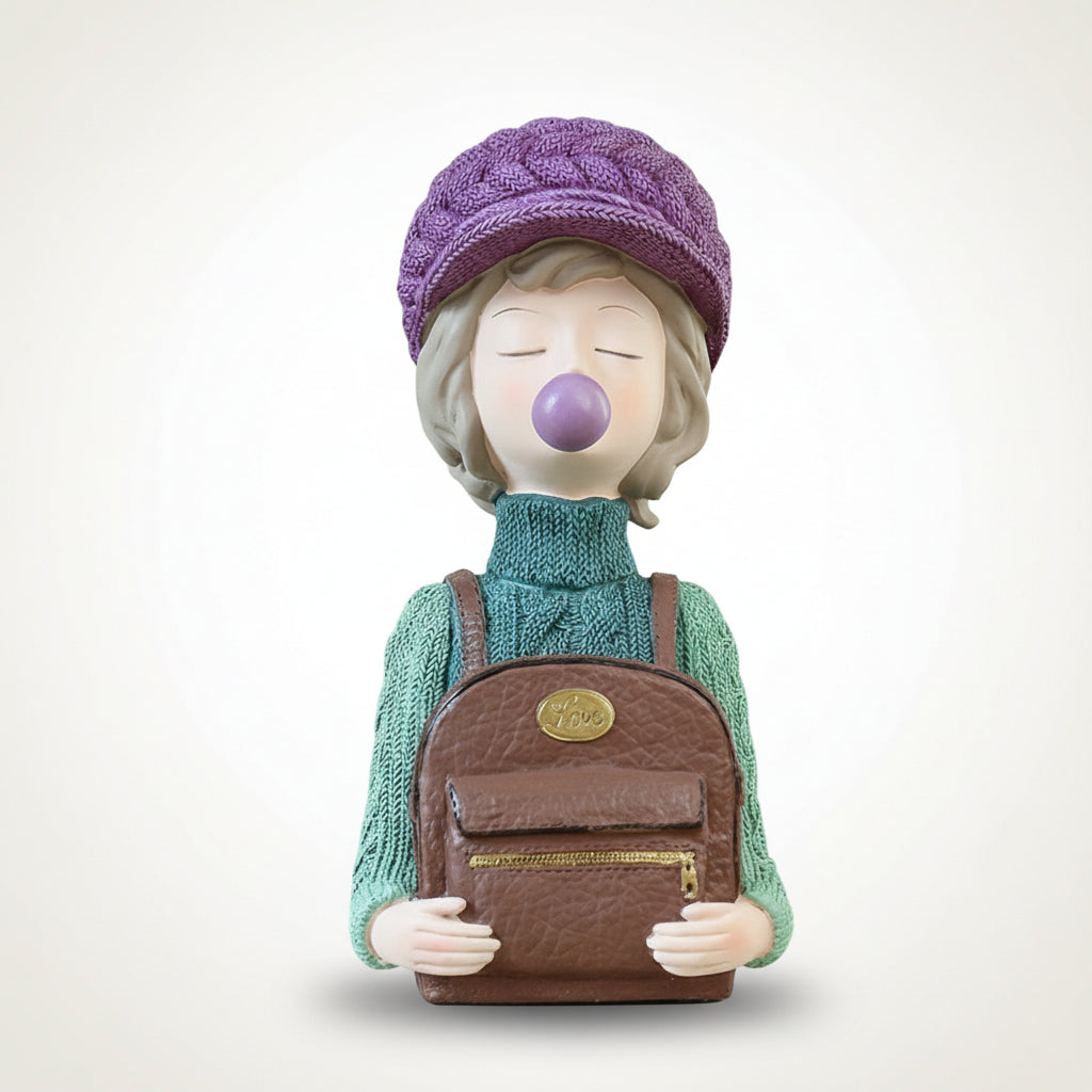 Decorative figurine of a person wearing a purple knitted hat and green sweater, holding a brown bag with a gold zipper.