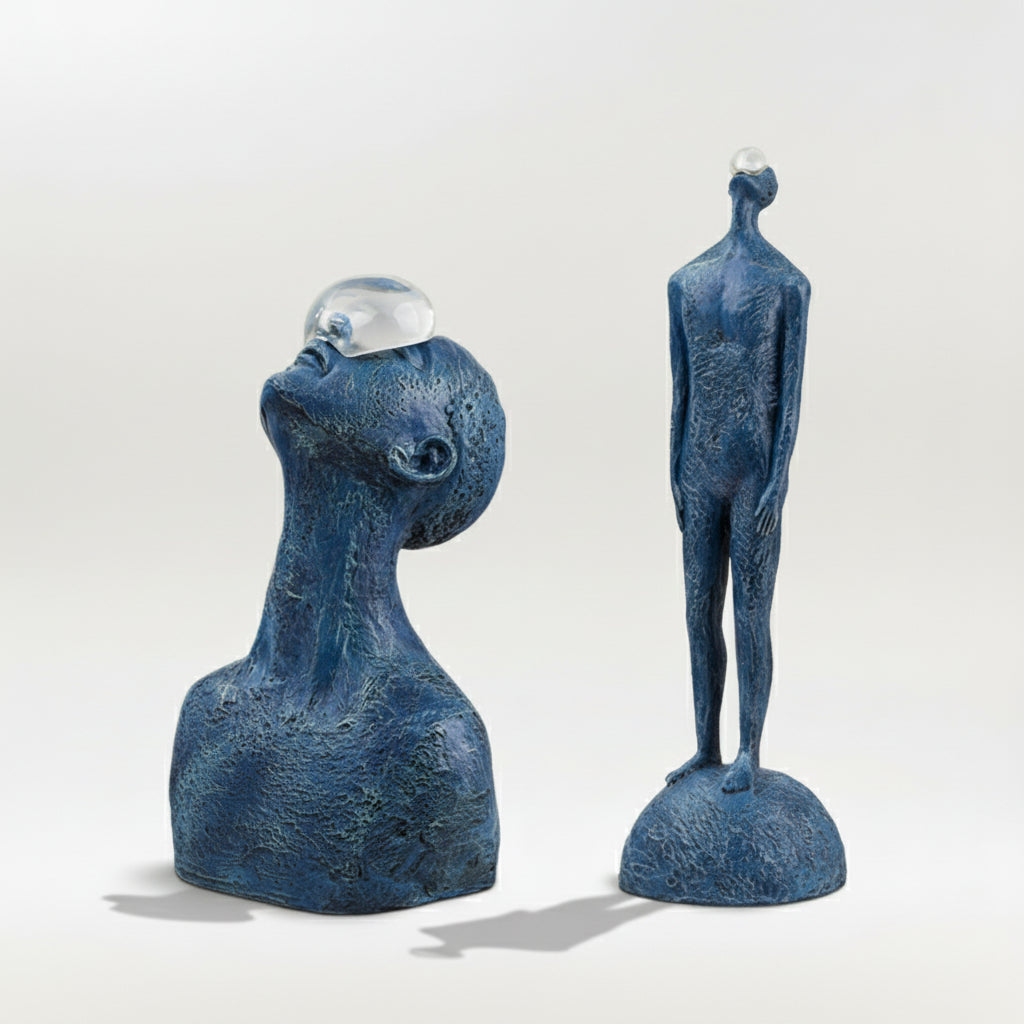 Two blue abstract sculptures on a white background